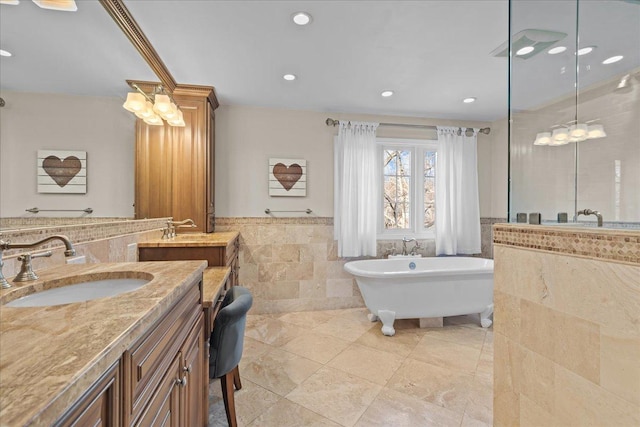 bathroom featuring vanity, tile walls, and a washtub