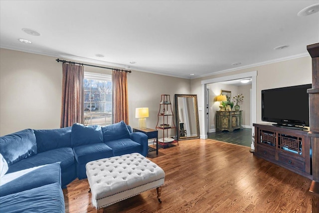 living room with dark hardwood / wood-style flooring and crown molding