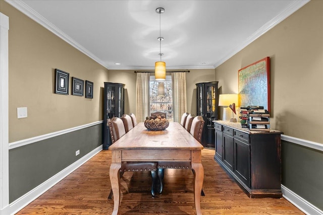 dining area with crown molding and dark hardwood / wood-style floors