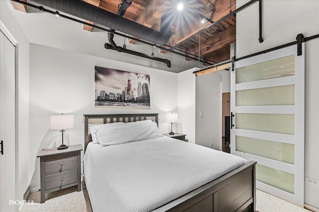 carpeted bedroom with a barn door