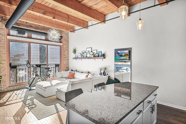 interior space featuring beamed ceiling, dark hardwood / wood-style floors, and wood ceiling