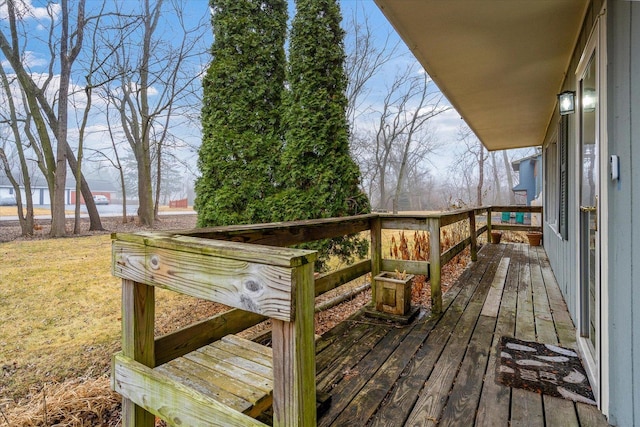 wooden deck with a water view and a yard