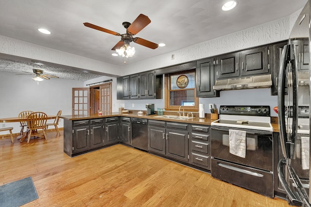 kitchen with sink, ceiling fan, black appliances, light hardwood / wood-style floors, and kitchen peninsula