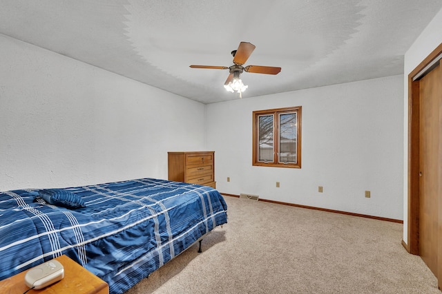 carpeted bedroom with ceiling fan and a closet