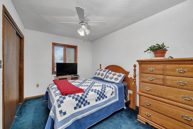 carpeted bedroom with ceiling fan and a closet