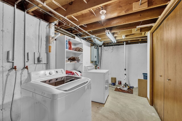 clothes washing area with water heater and washer and dryer