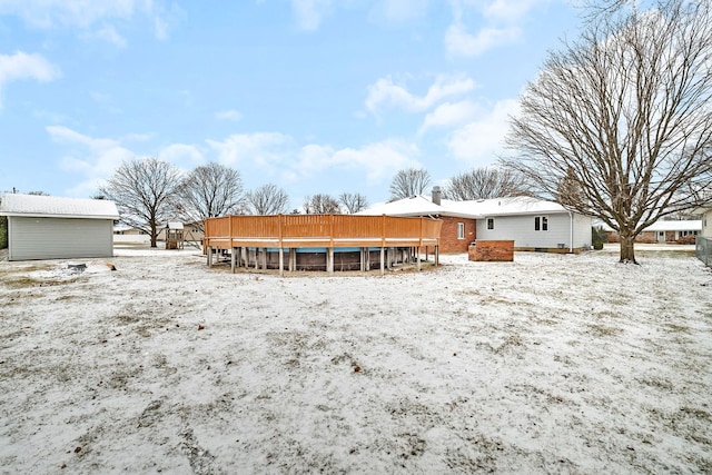 snow covered house featuring a swimming pool side deck