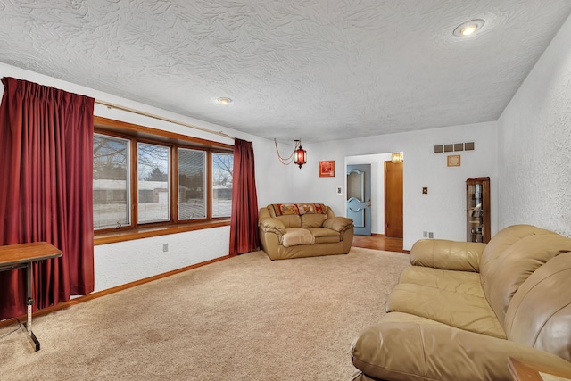 living room featuring carpet and a textured ceiling