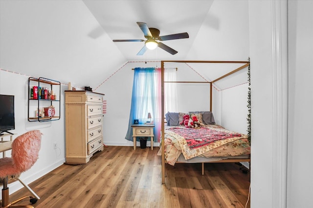 bedroom featuring vaulted ceiling, hardwood / wood-style floors, and ceiling fan