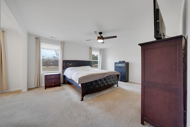 bedroom with ceiling fan and light colored carpet