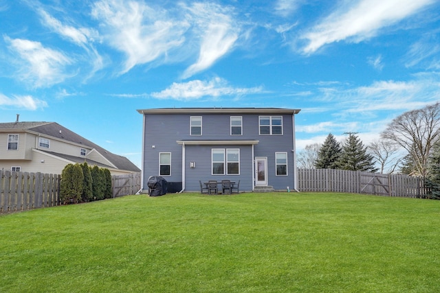 rear view of property with a lawn