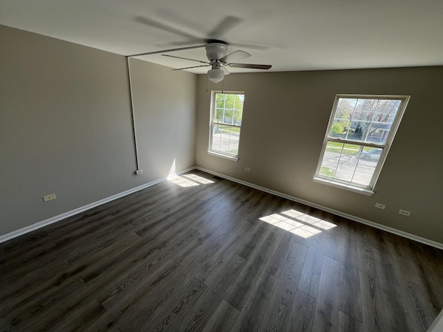 unfurnished room with ceiling fan, a healthy amount of sunlight, and dark hardwood / wood-style floors