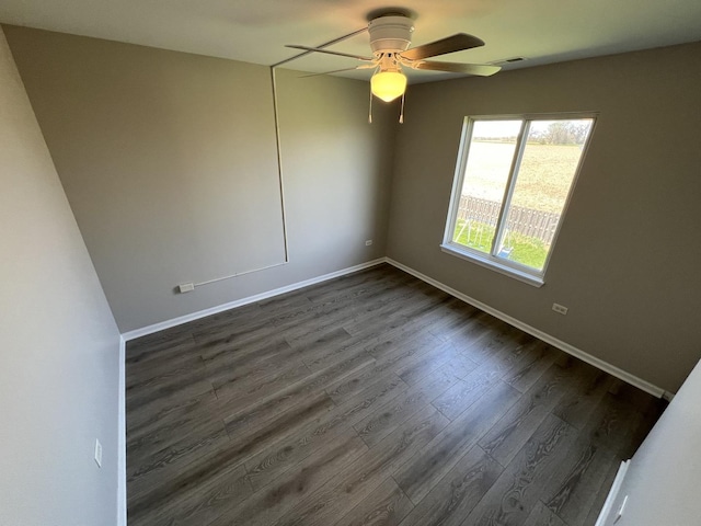 spare room with dark hardwood / wood-style floors and ceiling fan