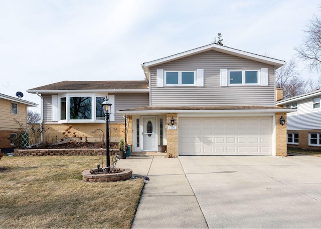 tri-level home with a garage and a front lawn