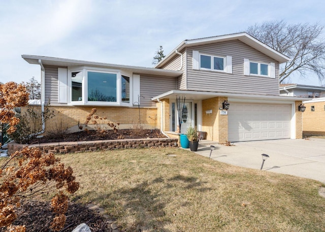 tri-level home featuring a garage and a front lawn