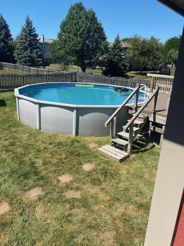 view of pool featuring a yard, fence, and a fenced in pool