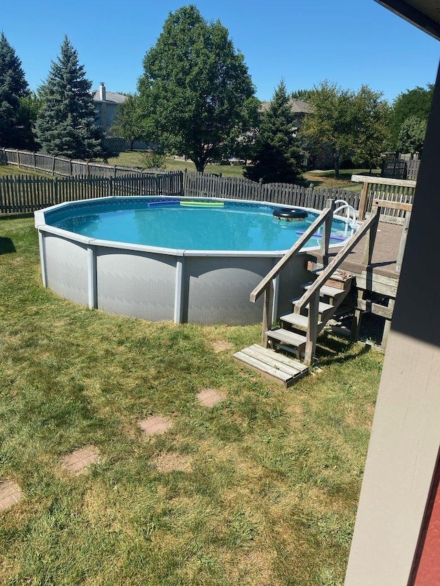 view of pool with fence, a lawn, and a fenced in pool