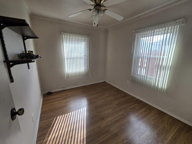 empty room featuring ceiling fan, crown molding, and dark hardwood / wood-style flooring