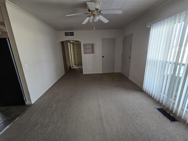 carpeted empty room with crown molding and ceiling fan