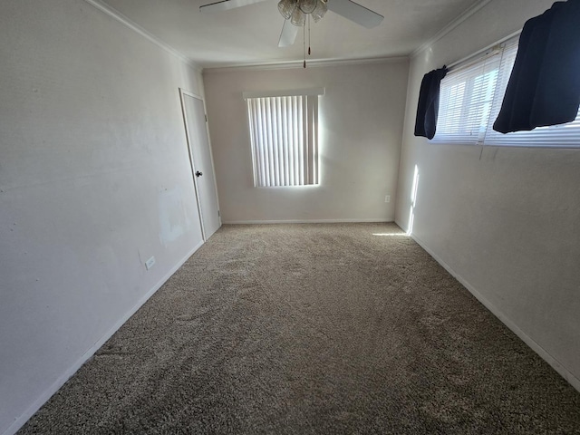 unfurnished room with crown molding, carpet flooring, and ceiling fan