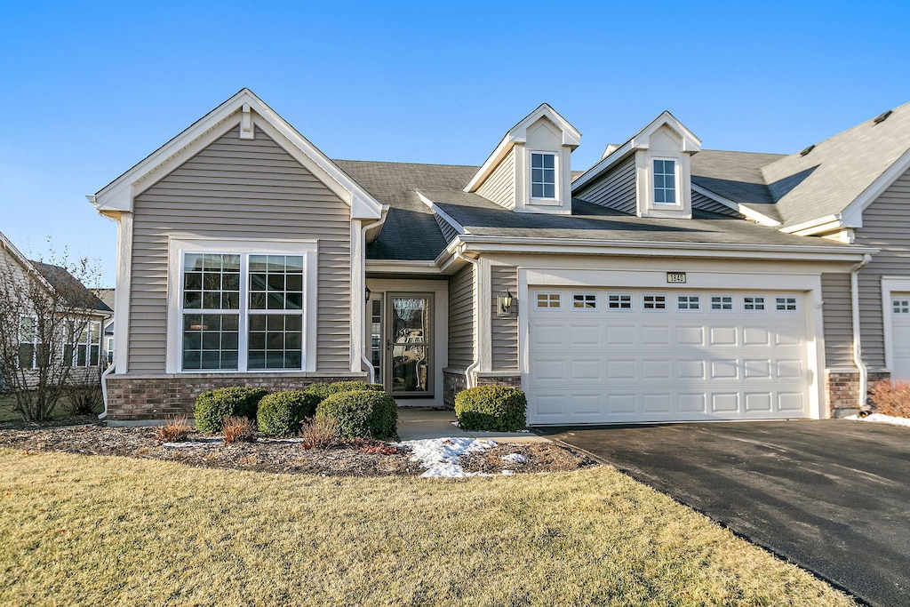 view of front of house with a garage and a front yard