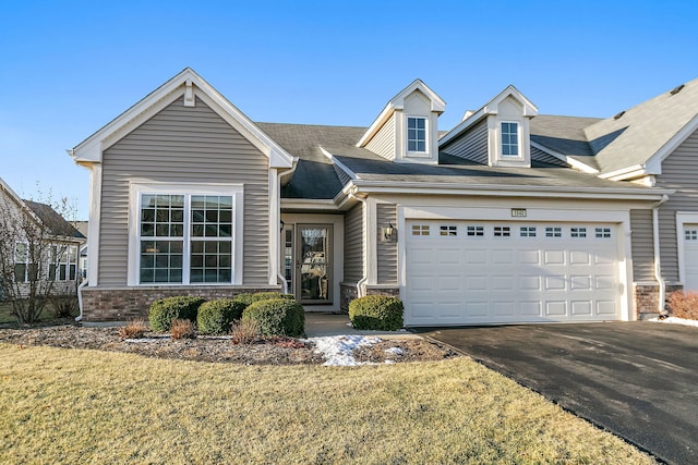 view of front of house with a garage and a front yard