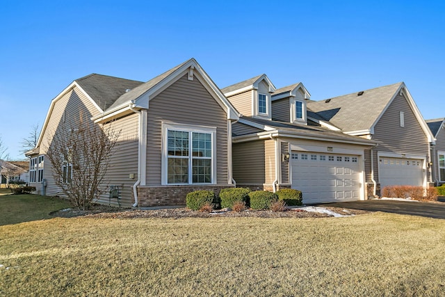 view of front of home featuring a garage and a front yard