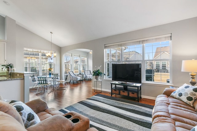 living room featuring lofted ceiling, dark hardwood / wood-style floors, sink, and a notable chandelier