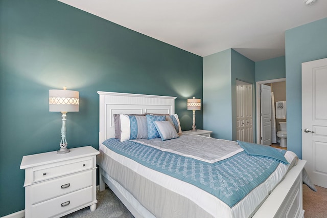 carpeted bedroom featuring ensuite bathroom