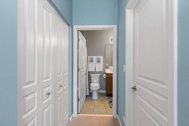 bathroom featuring tile patterned floors, vanity, and toilet