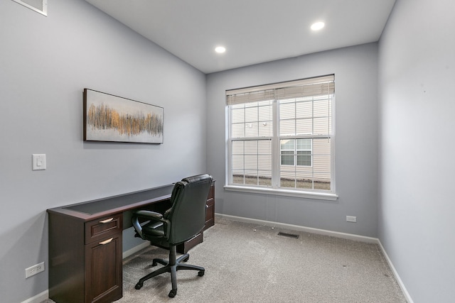 office area featuring light carpet