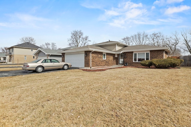 ranch-style home featuring a front yard, brick siding, and an attached garage