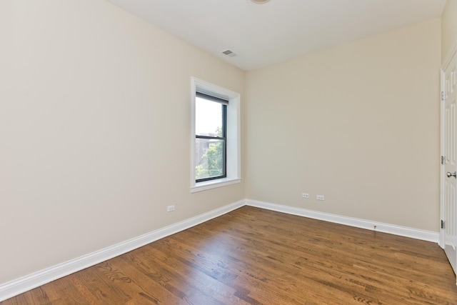 spare room with hardwood / wood-style flooring