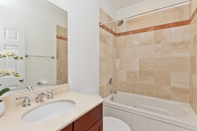 full bathroom featuring vanity, toilet, and tiled shower / bath