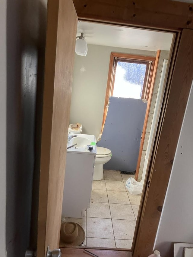 bathroom featuring tile patterned flooring, vanity, and toilet