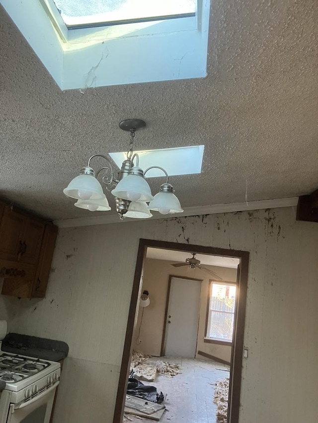 interior space with white range with gas cooktop and a skylight