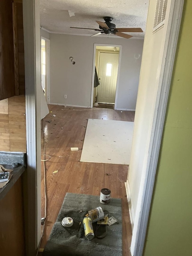 corridor featuring hardwood / wood-style floors and a textured ceiling