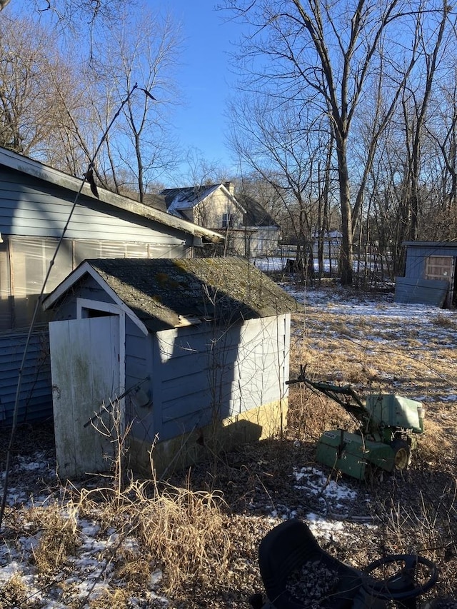 view of side of home with a shed