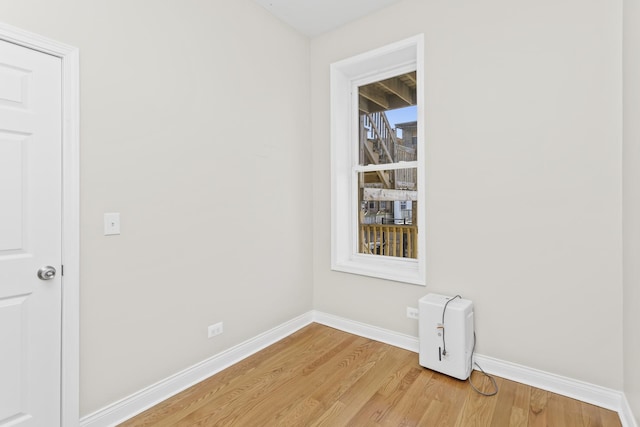 unfurnished room featuring a wealth of natural light and light hardwood / wood-style floors