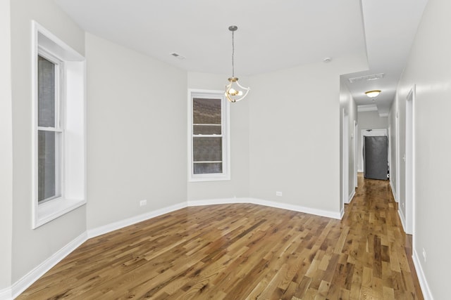 unfurnished dining area featuring wood-type flooring