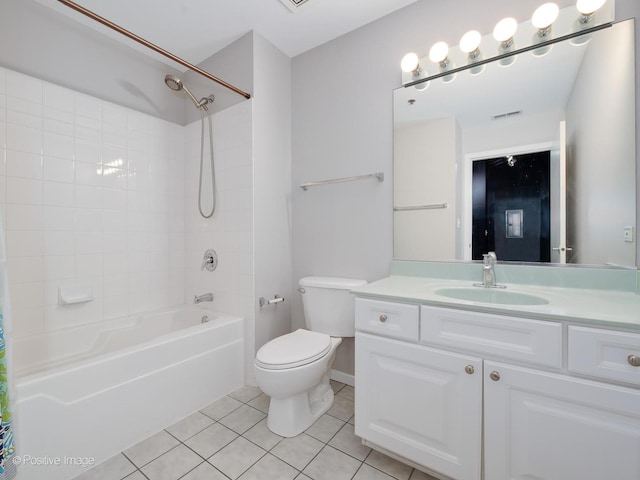 full bathroom featuring tiled shower / bath, vanity, tile patterned floors, and toilet