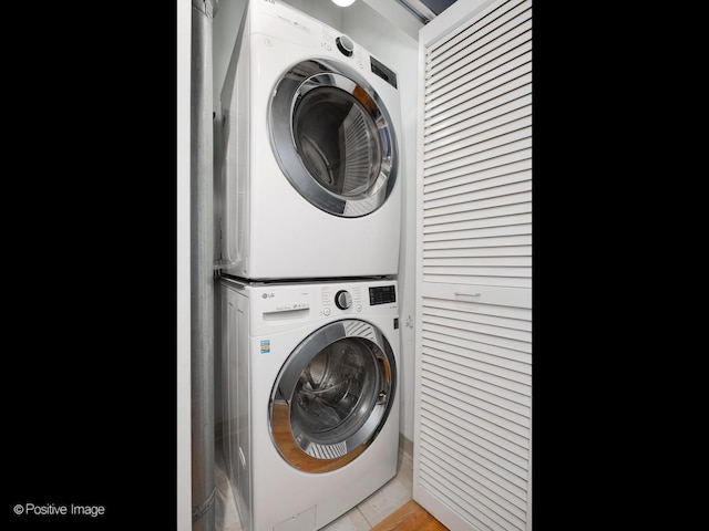 clothes washing area with stacked washer and dryer