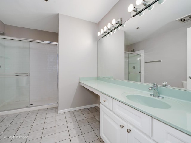 bathroom with vanity, tile patterned floors, and a shower with shower door