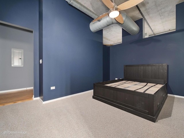 bedroom with carpet flooring, electric panel, and ceiling fan