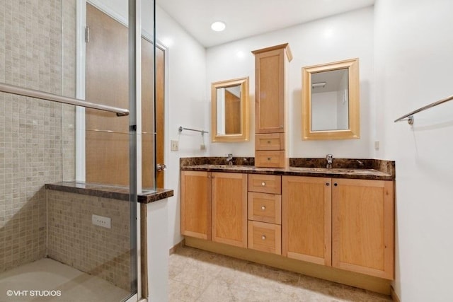 bathroom with vanity and a shower with shower door