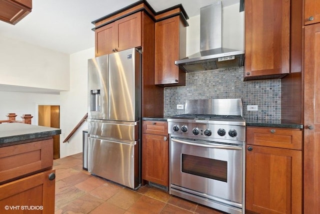 kitchen featuring appliances with stainless steel finishes, wall chimney range hood, and backsplash