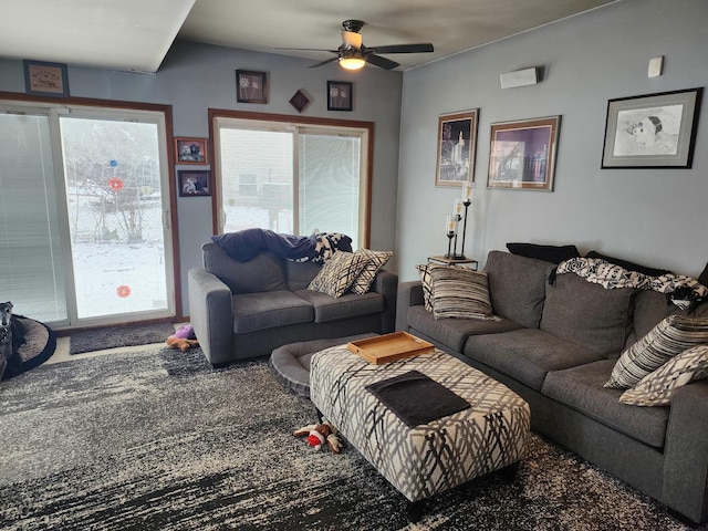 carpeted living room with ceiling fan