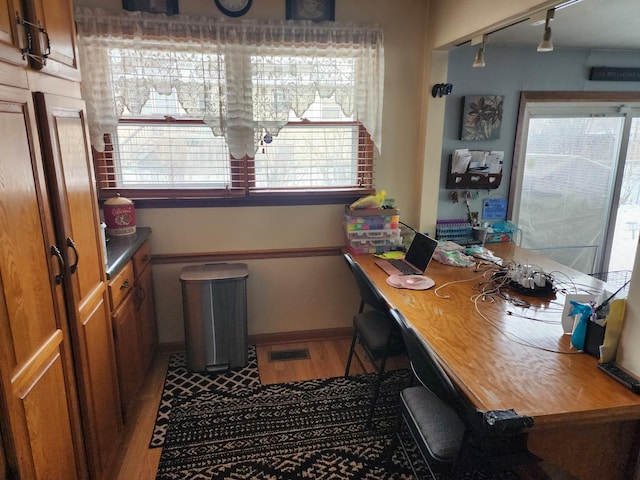 home office with hardwood / wood-style floors