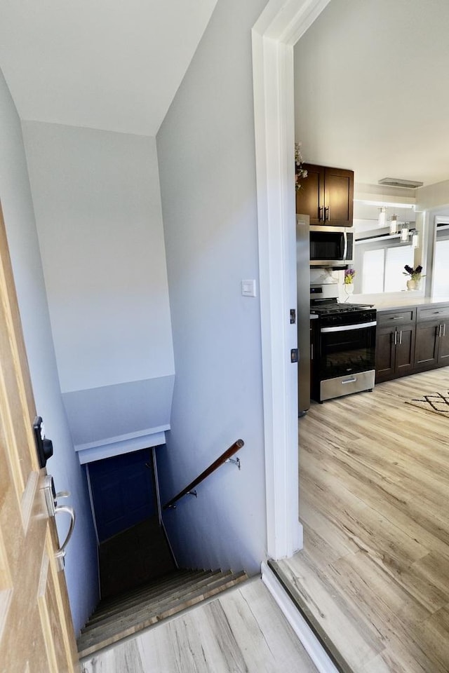 stairs featuring hardwood / wood-style flooring