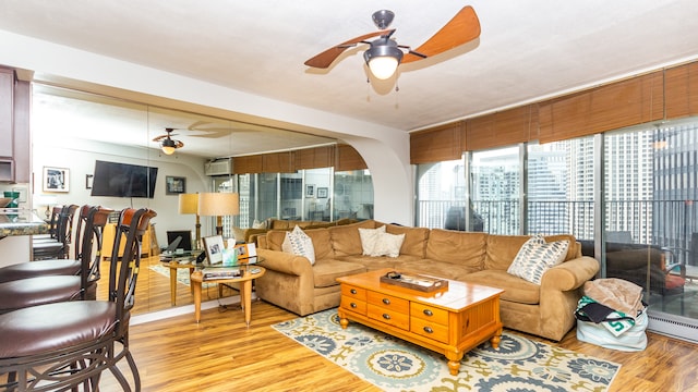 300 N State St Unit 2830, Chicago, IL 60654 - living area featuring a ceiling fan, light wood-style flooring, an AC wall unit, and a baseboard radiator